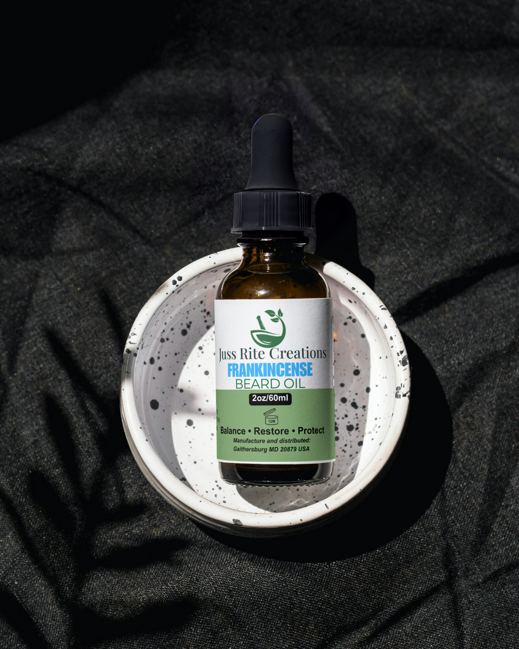 Bottle of Frankincense Beard Oil on a dark textured background