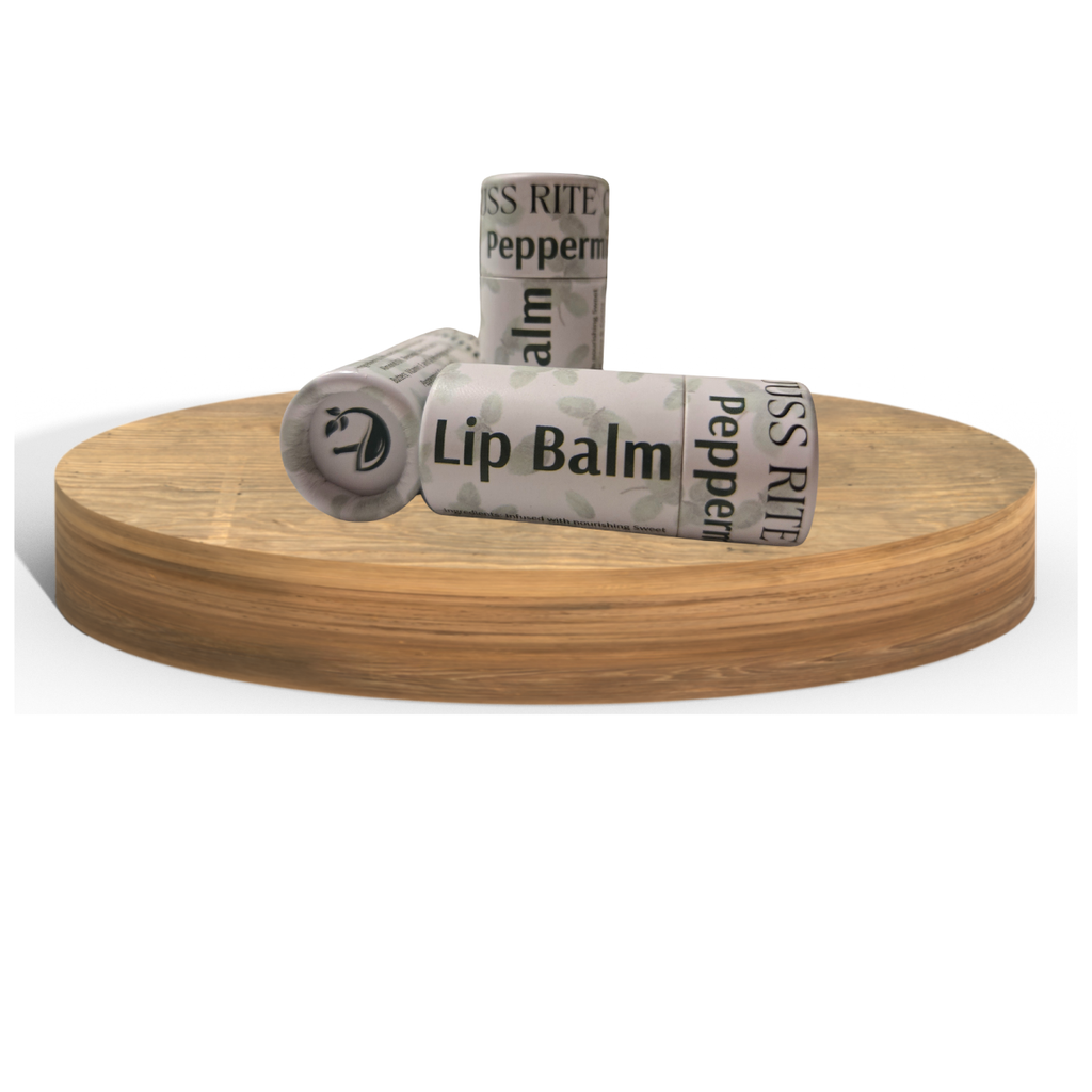 Three lip balm tubes wrapped in paper on a wooden stand with a white background