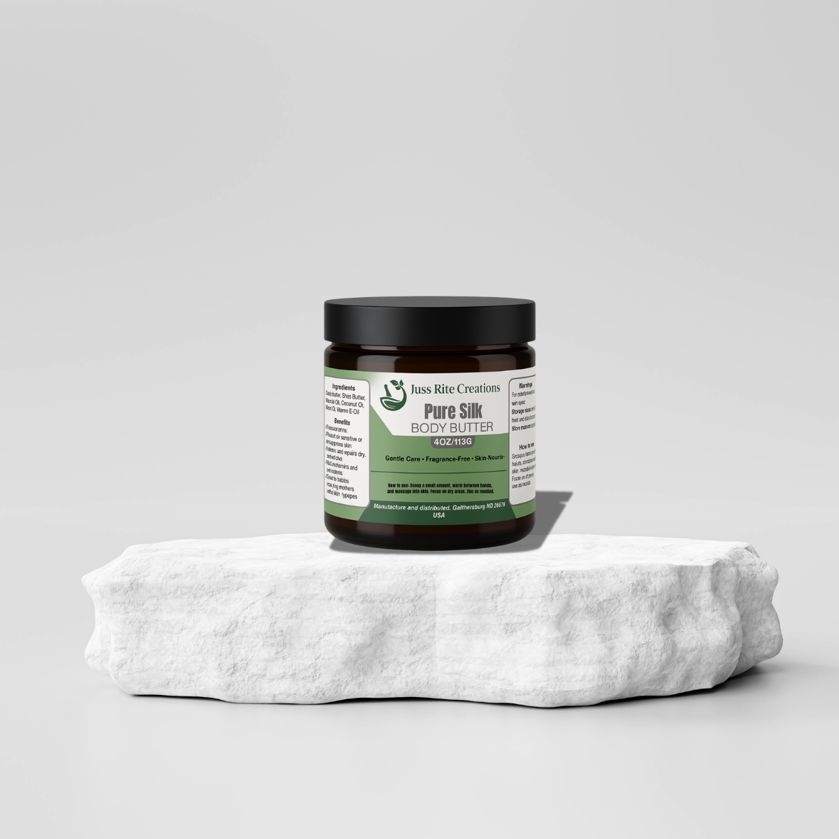 Jar of Pure Silk Body Butter on a white towel with a gray background