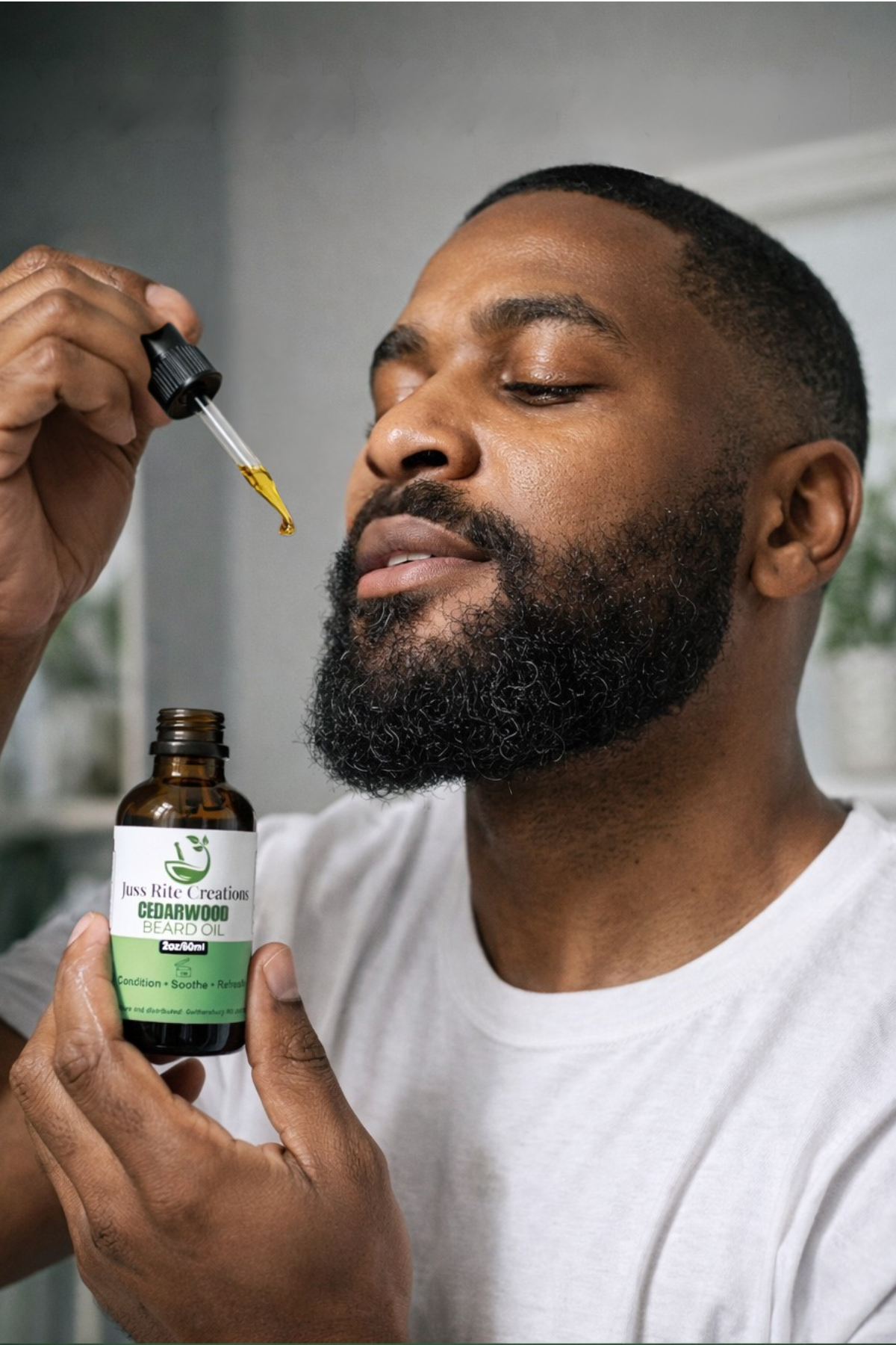 Man holding a bottle of cedarwood essential oil and using a dropper.