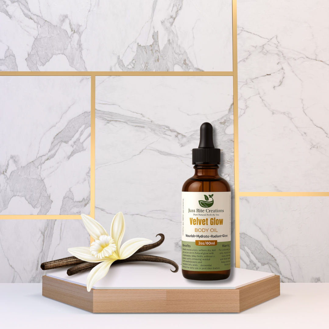 Bottle of Juss Rite Creations Velvet Glow body oil with vanilla bean and flower on a marble background