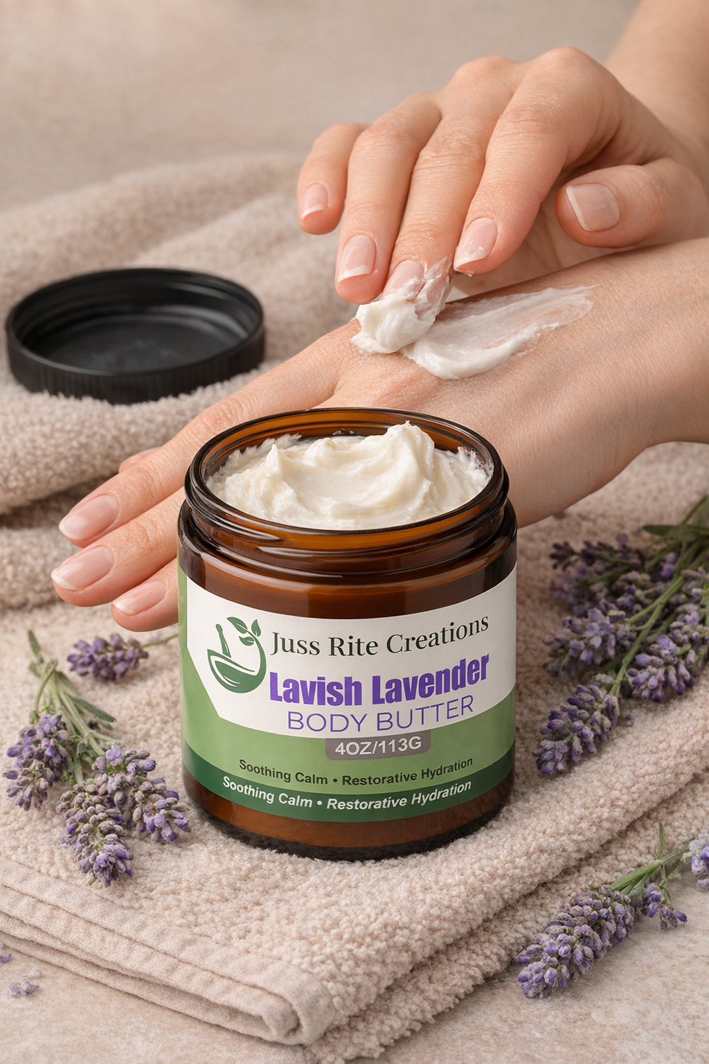 Jar of Lavish Lavender Body Butter with hand applying cream, surrounded by lavender flowers on a beige towel.