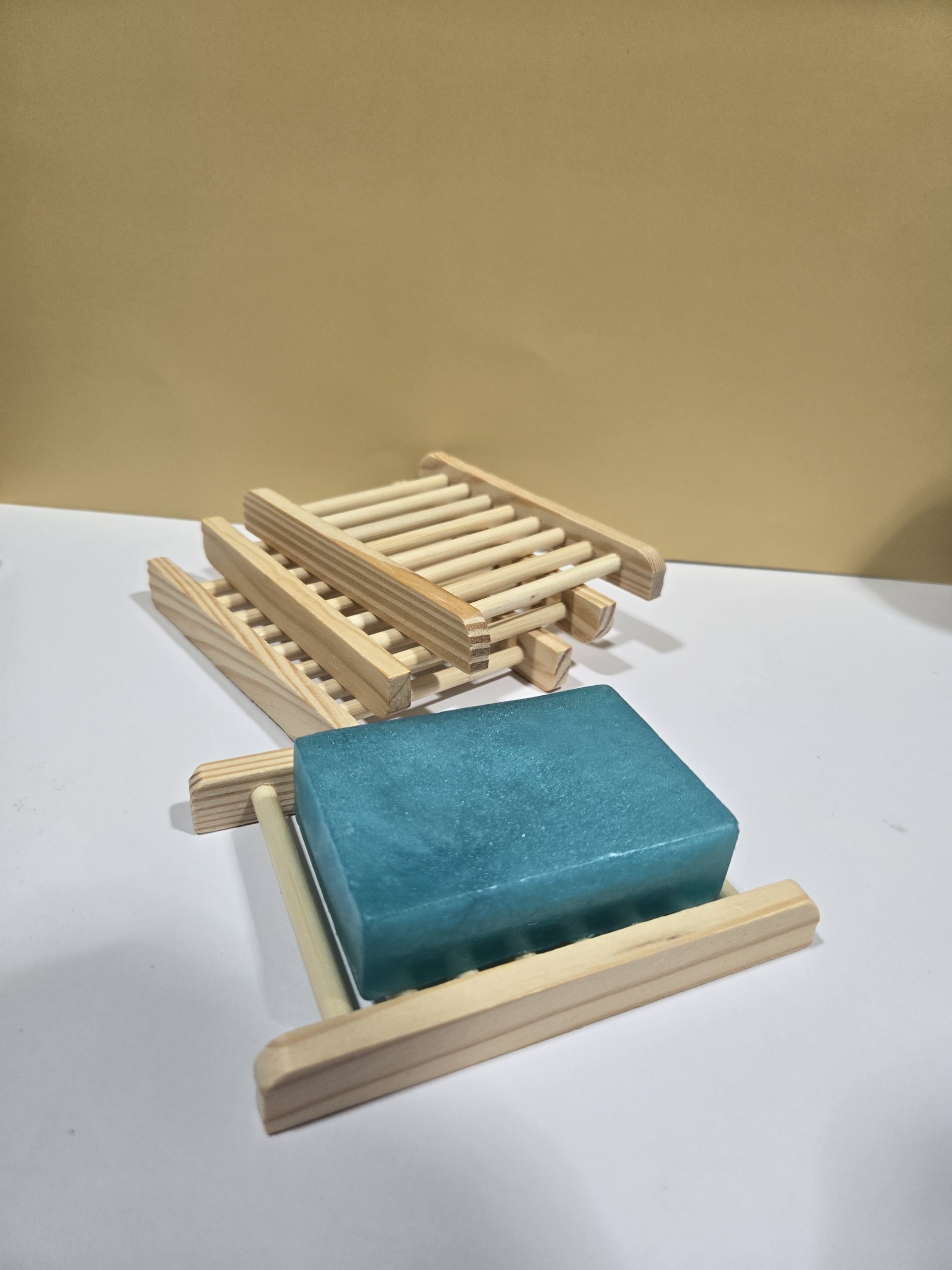 Bamboo Wood Soap Holder stacked together and one displaying a soap.