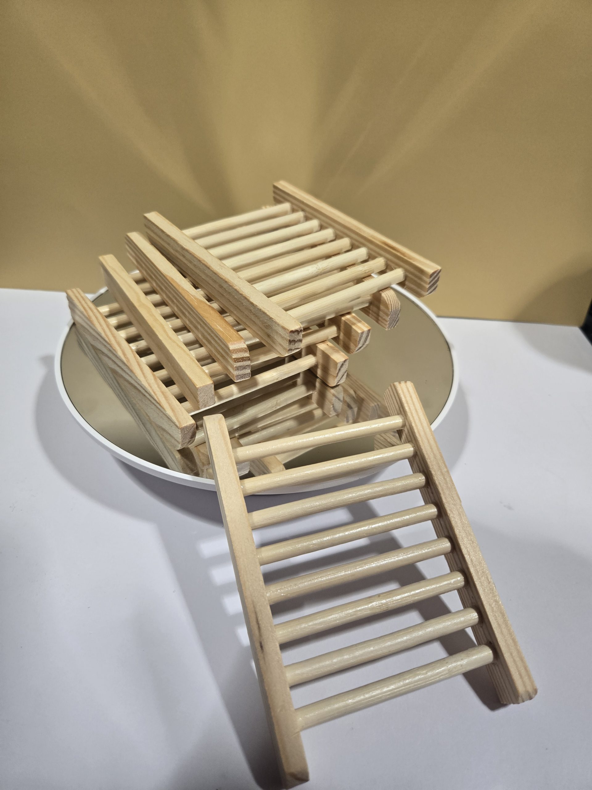 Bamboo wood soap holder are stacked together with one leaning upright to display the ridges.